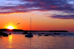 Sunset over water with boats